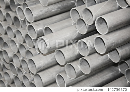 Metal steel pipe for construction materials, aluminium or stainless steel products on a factory or warehouse. Metal steel pipe for construction materials, aluminium or stainless steel products on a factory or warehouse. 142756870