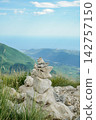 Stone Cairn Pyramid on Mountain Summit with Scenic Landscape Background 142757150