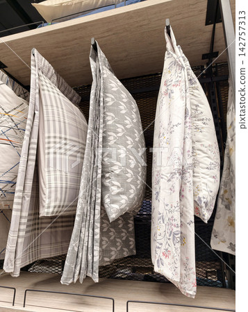 Pillows and cushion covers hanging on display racks in home boutique Pillows and cushion covers hanging on display racks in home boutique 142757313