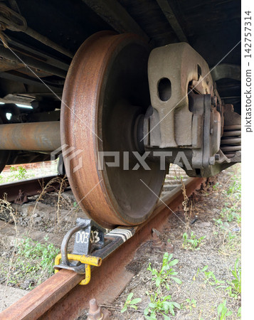 Safety brake block under metal wheel of cargo train preventing unintended movement 142757314