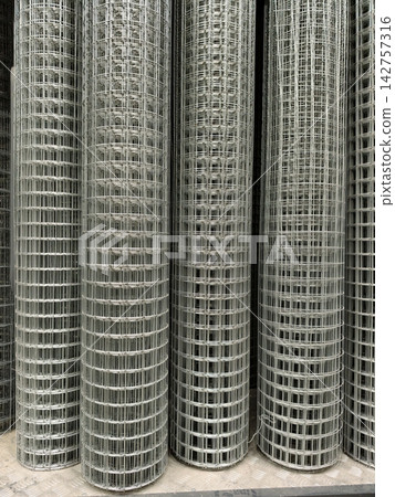 Rolled galvanized mesh with welded connections available in a supermarket specializing in construction materials Rolled galvanized mesh with welded connections available in a supermarket specializing in construction materials 142757316