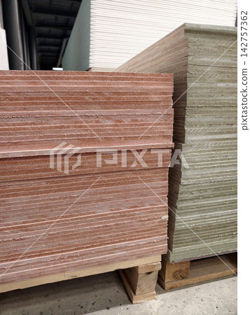 Magnesite plates displayed in construction supply store with stacked building boards and hardware supermarket interior detail Magnesite plates displayed in construction supply store with stacked building boards and hardware supermarket interior detail 142757362