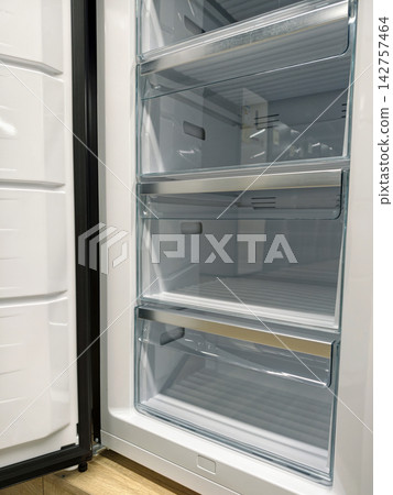 Newly designed fridge with open door, now for sale in a home electronics store Newly designed fridge with open door, now for sale in a home electronics store 142757464