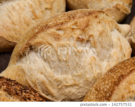 Fluffy white bread offered in a bakery, highlighting a soft loaf with a fresh texture prepared for customers looking for quality bread Fluffy white bread offered in a bakery, highlighting a soft loaf with a fresh texture prepared for customers looking for quality bread 142757531