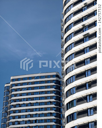 Recently completed residential buildings with attractive facades and countless apartment windows Recently completed residential buildings with attractive facades and countless apartment windows 142757532