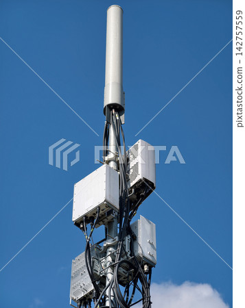 A 5G network tower transmitting data signals under the open sky A 5G network tower transmitting data signals under the open sky 142757559