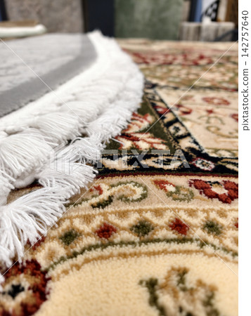 Rug tassels displayed in close up revealing detailed weaving and premium craftsmanship Rug tassels displayed in close up revealing detailed weaving and premium craftsmanship 142757640