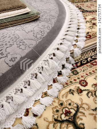 Fringe on a carpet edge highlighting quality craftsmanship and elegant textile finish Fringe on a carpet edge highlighting quality craftsmanship and elegant textile finish 142757734