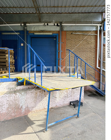 Delivery area behind a grocery store with space for unloading shipments receiving products and supporting organized retail supply operations Delivery area behind a grocery store with space for unloading shipments receiving products and supporting organized retail supply operations 142757773