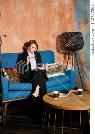 Professional observes report carefully in comfortable environment Professional observes report carefully in comfortable environment 142757868