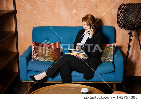 Silent environment where woman reads calmly with coffee in hand Silent environment where woman reads calmly with coffee in hand 142757885