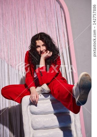 Playful caucasian woman in red suit, creative artist pose Playful caucasian woman in red suit, creative artist pose 142757886
