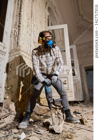 Skilled craftsman restoring vintage mansion amid debris and dust Skilled craftsman restoring vintage mansion amid debris and dust 142757916