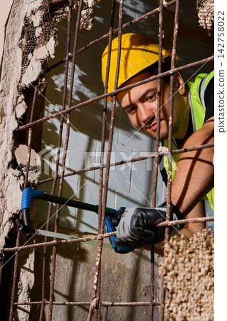 Facial expression highlighting concentration during manual labor Facial expression highlighting concentration during manual labor 142758022