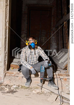 Craftsman in relaxed position surrounded by building remnants Craftsman in relaxed position surrounded by building remnants 142758088