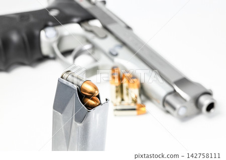 bullet 9mm FMJ (Full Metal Jacketed ) Shell Shock Technologies (NAS3) in magazines and 9mm postal gun in background. bullet 9mm FMJ (Full Metal Jacketed ) Shell Shock Technologies (NAS3) in magazines and 9mm postal gun in background. 142758111