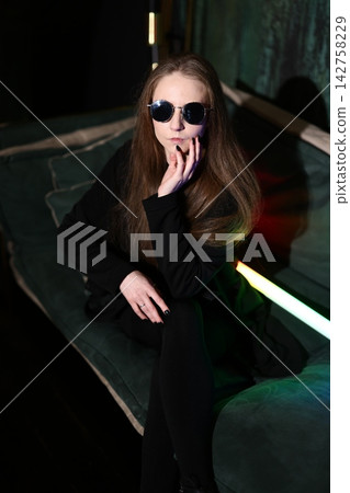 Chic female figure in vibrant neon illuminated environment Chic female figure in vibrant neon illuminated environment 142758229