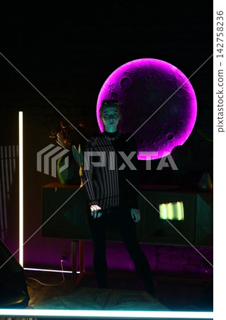 Nighttime city scene with glowing performer under moonlight Nighttime city scene with glowing performer under moonlight 142758236
