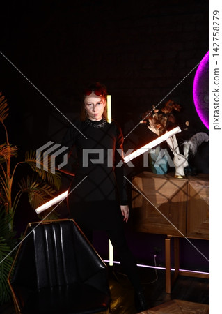 Modern demonstration of woman highlighting neon illuminated product design Modern demonstration of woman highlighting neon illuminated product design 142758279