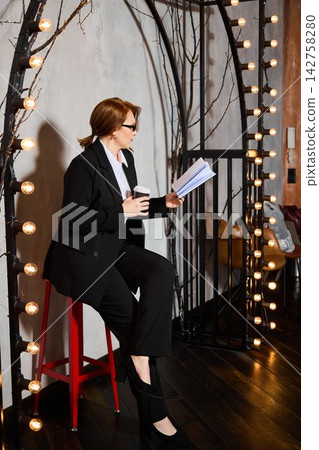 Professional woman rehearsing keynote behind arched frame with lighting Professional woman rehearsing keynote behind arched frame with lighting 142758280