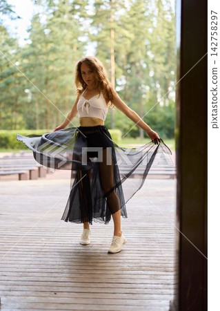 Relaxed woman in boho style on wooden platform by lake Relaxed woman in boho style on wooden platform by lake 142758297