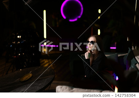 Lounge scene with woman contemplating neon light and peaceful feelings Lounge scene with woman contemplating neon light and peaceful feelings 142758304