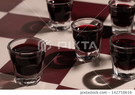 shots with chocolate wine, chess tiles on the table, hard light, no people, shots with chocolate wine, chess tiles on the table, hard light, no people, 142758616