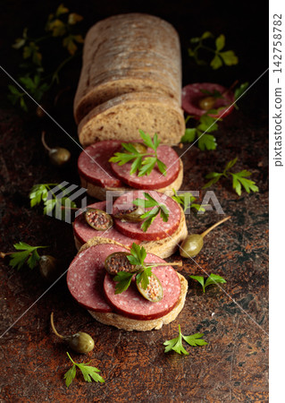 Sandwiches with smoked sausage on a vintage background. Sandwiches with smoked sausage on a vintage background. 142758782
