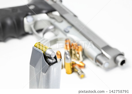 bullet 9mm parabellum LRN ( lead round nose ) semi-wadcutter (SWC) in magazines and 9mm postal gun in background. bullet 9mm parabellum LRN ( lead round nose ) semi-wadcutter (SWC) in magazines and 9mm postal gun in background. 142758791