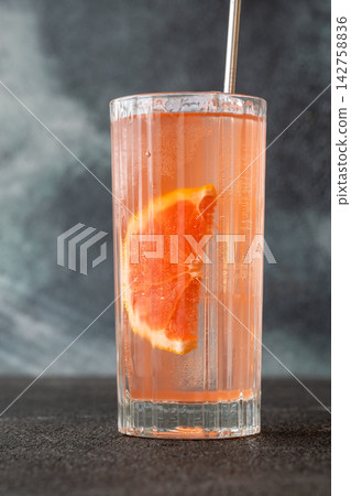 Refreshing pink Paloma cocktail with grapefruit ice bubbles and modern metal straw Refreshing pink Paloma cocktail with grapefruit ice bubbles and modern metal straw 142758836