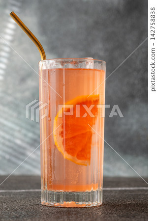 Refreshing pink Paloma cocktail with grapefruit ice bubbles and modern metal straw Refreshing pink Paloma cocktail with grapefruit ice bubbles and modern metal straw 142758838