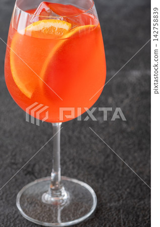 Vibrant Campari Spritz cocktail with citrus ice bubbles elegant Italian aperitif presentation Vibrant Campari Spritz cocktail with citrus ice bubbles elegant Italian aperitif presentation 142758839
