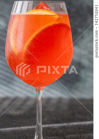 Vibrant Campari Spritz cocktail with citrus ice bubbles elegant Italian aperitif presentation Vibrant Campari Spritz cocktail with citrus ice bubbles elegant Italian aperitif presentation 142758841