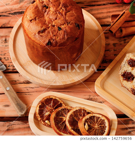 Panettone filled with creamy chocolate on a wooden table during Christmas festivities. Panettone filled with creamy chocolate on a wooden table during Christmas festivities. 142759656