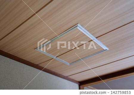 An inspection hatch in the wood-grain ceiling of a house. It has a silver metal frame. An inspection hatch in the wood-grain ceiling of a house. It has a silver metal frame. 142759853