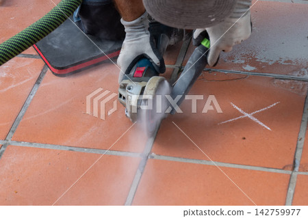 Worker Cutting Terracotta Floor Tiles with Angle Grinder and Dust Worker Cutting Terracotta Floor Tiles with Angle Grinder and Dust 142759977