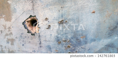 Damaged Concrete Wall with a Deep Impact Hole Damaged Concrete Wall with a Deep Impact Hole 142761803