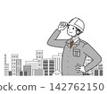 A businessman on site looking out at the building. 142762150