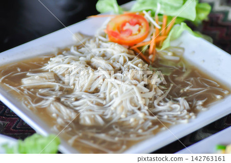 stir fried mushroom , stir fried golden needle mushroom or enoki mushroom or Flammulina filiformis or flammulina valutipes stir fried mushroom , stir fried golden needle mushroom or enoki mushroom or Flammulina filiformis or flammulina valutipes 142763161