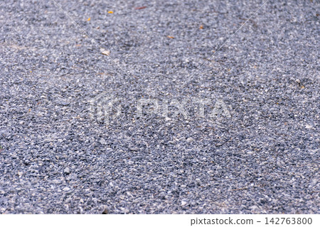 Close view of gray crushed gravel stones covering the ground rough uneven texture suitable for construction landscaping pathways outdoor surface backgrounds Close view of gray crushed gravel stones covering the ground rough uneven texture suitable for construction landscaping pathways outdoor surface backgrounds 142763800
