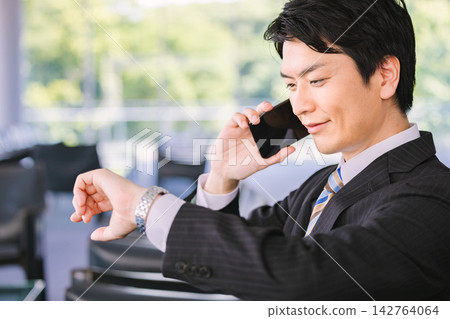 A businessman calling on a smartphone A businessman calling on a smartphone 142764064