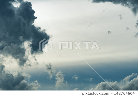 Dramatic dark storm clouds surrounding opening in sky, atmospheric cloudscape suggesting changing weather, approaching storm, nature, uncertainty and climate. Weather background for climate, rainfall. Dramatic dark storm clouds surrounding opening in sky, atmospheric cloudscape suggesting changing weather, approaching storm, nature, uncertainty and climate. Weather background for climate, rainfall. 142764604