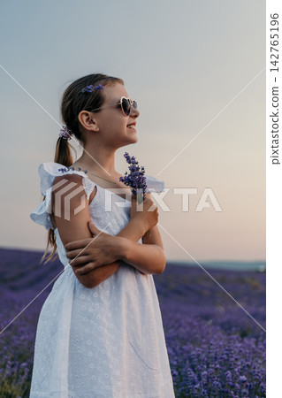 Lavender girl field sunset portrait of a happy child holding purple flowers while wearing a white summer dress and heart sunglasses Lavender girl field sunset portrait of a happy child holding purple flowers while wearing a white summer dress and heart sunglasses 142765196