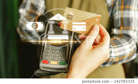 Online payment process at a store with a card reader and customer interacting 142765335