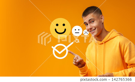 Person in an orange hoodie points at smiley faces with different emotions and a check mark symbol 142765366