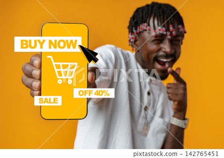 Shopping for deals online with a mobile phone displaying a sale sign in a bright setting 142765451