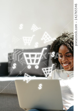 Online shopping at home with a laptop and shopping carts in the air Online shopping at home with a laptop and shopping carts in the air 142765546