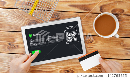 Online payment process using a tablet and QR code with a coffee cup nearby 142765855