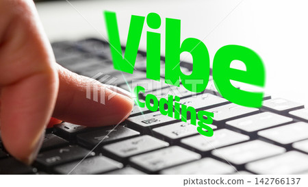 Vibe coding on keyboard showing hand pressing a key while working on a project Vibe coding on keyboard showing hand pressing a key while working on a project 142766137