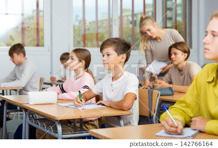 Schoolboy posing in classroom during lesson 142766164